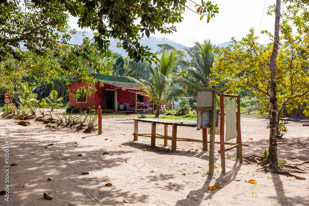 House in the Castelhanos beach Ilhabela, tropical trees and travelers, in famous paradise on Sao Paulo coast in Brazil House in the Castelhanos beach Ilhabela, tropical trees and travelers, in famous paradise on Sao Paulo coast in Brazil