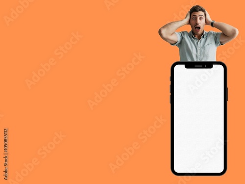 Cheerful plump young man in his 20s in smart clothes standing on mobile phone with blank screen and isolated work area and people's lifestyle concept photo