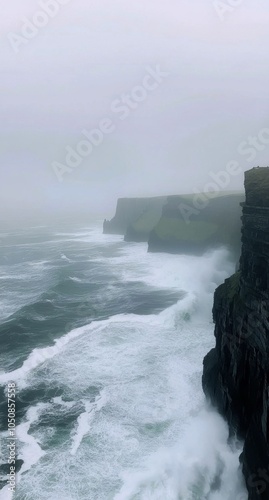 Misty cliffs at the edge of the atlantic ocean on a foggy day in ireland