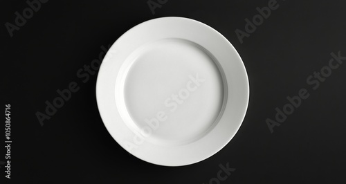 Simple white plate on a dark background showcasing minimalist design and eleg...