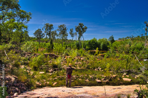 Woman hiker looking out over the rocky and green landscape along the Sweetwater Pool Walk, Edith Falls (Leliyn), Nitmiluk National Park, Katherine, Northern Territory, Australia
 photo