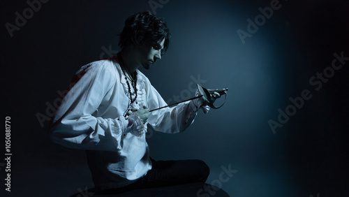 A dramatic hero with a sword in his hands, suffering from defeat and injury, a portrait in the moonlight, drama or theater photo