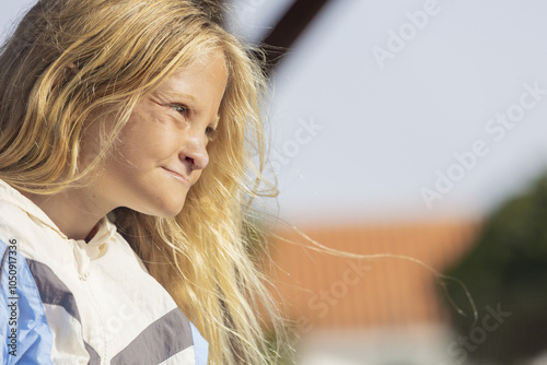 Young girl enjoying a sunny day despite medical challenges photo