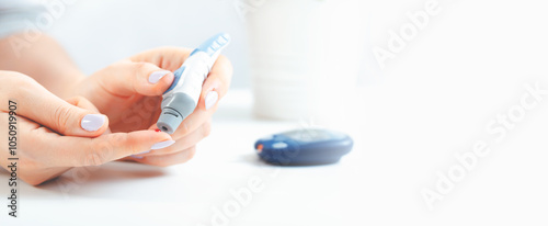 Woman is holding a glucometer