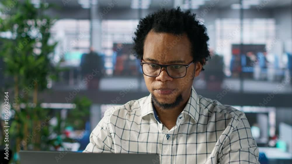Stressed business manager working under pressure on important tasks, dealing with burnout and mental exhaustion. African american man feeling overwhelmed by deadlines. Camera A.