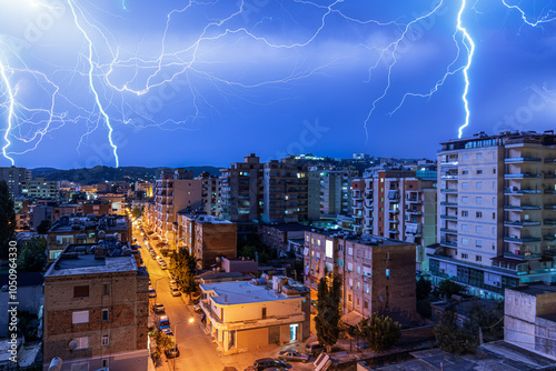 Scary lightning over houses at night during a strong thunderstorm photo