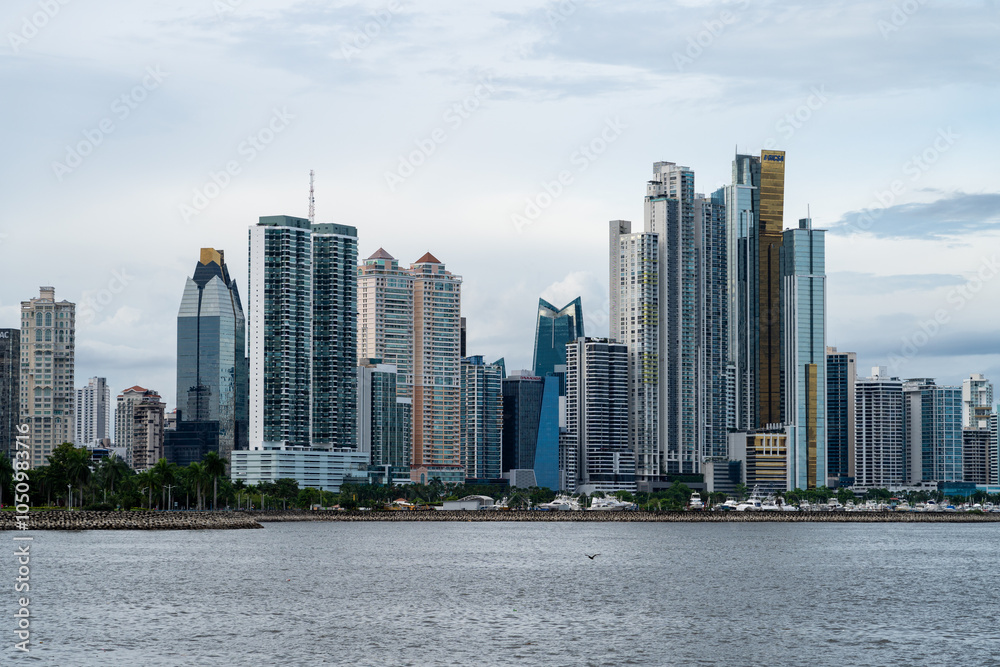Obraz premium Cluster of modern skyscrapers in Panama City, with boats and park underneath. Viewed from across the water