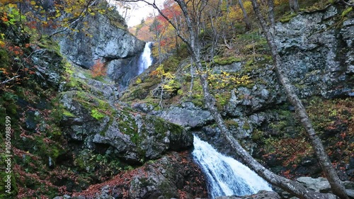 Uisge Ban Falls, Cape Breton, Nova Scotia, Canada. Cascading waterfalls with stunning autumn fall foliage colors. 