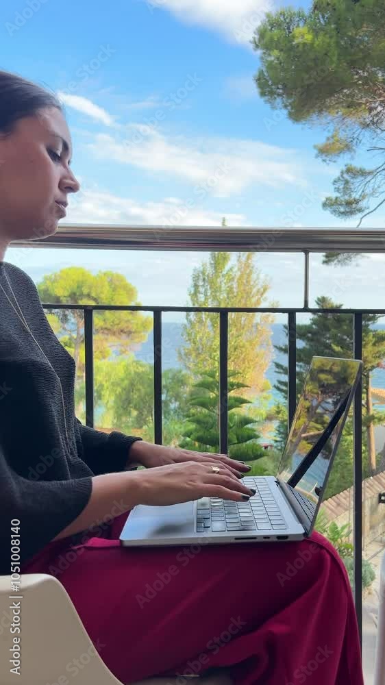 Freelance Woman Working on Laptop with Ocean View 