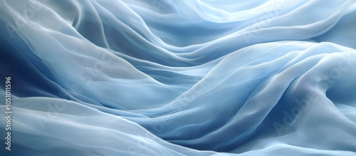 Abstract background of blue chiffon fabric with smooth flowing waves and soft textures.