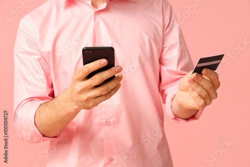 Young businessman with mobi...