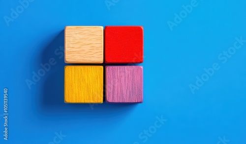 A set of vibrant wooden blocks in red, yellow, purple, and natural wood sits neatly on a vivid blue backdrop, encouraging imaginative play