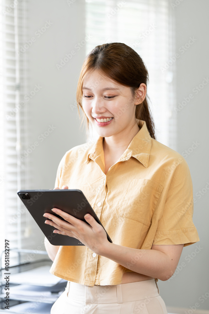 Attractive woman working on a tablet in a home office. Attractive woman working on a tablet in a home office.