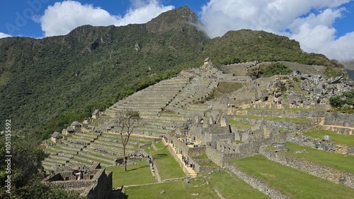 Long distance image of the terracing and buildings at the archaeological site of Machu Picchu in Peru