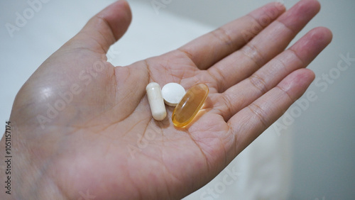 Woman hands take multivitamins, there are omega 3, zinc and vitamin D3 High Dose. Vitamin Consumption Routine. photo