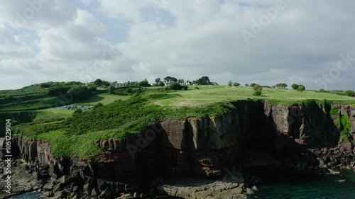 Orbiting drone shot of steep cliffs off of Ireland's coast. photo