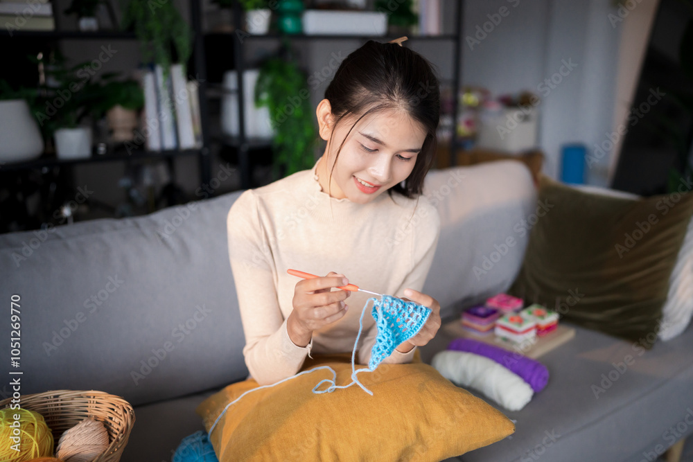 Obraz premium Happy young female asian woman hands crochets handmade crocheting supplies assorted yarn hook knitting handmade for crochet handcraft hobby for relax on sofa