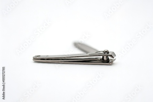 A metal nail clipper on a white background.