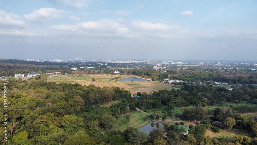 Obraz premium Aerial view of countryside meeting city skyline under cloudy sky in Chiang Mai Thailand