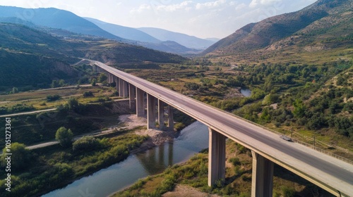 Drone View Bridge - High drone view of a bridge spanning a wide river or valley, showcasing its scale and architectural elegance.