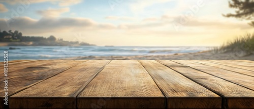 Fototapeta Naklejka Na Ścianę i Meble -  Long wooden table with a scenic beach landscape in the background, blurred view of coastal horizon on a sunny day