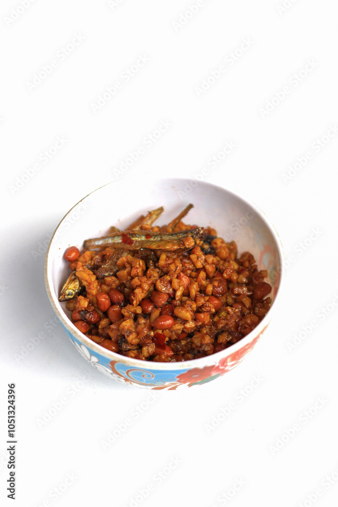 Indonesian dish dried tempeh, made from tempeh or soybeans cut into small pieces, cooked with chili, soy sauce and anchovies, isolated on white background Indonesian dish dried tempeh, made from tempeh or soybeans cut into small pieces, cooked with chili, soy sauce and anchovies, isolated on white background