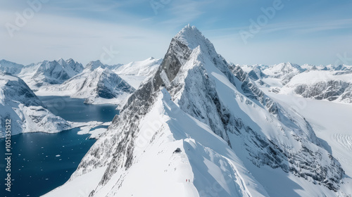 Majestic snow covered mountains rise sharply against clear blue sky, showcasing breathtaking beauty of nature. serene landscape features glacial lake surrounded by rugged peaks, evoking sense of
