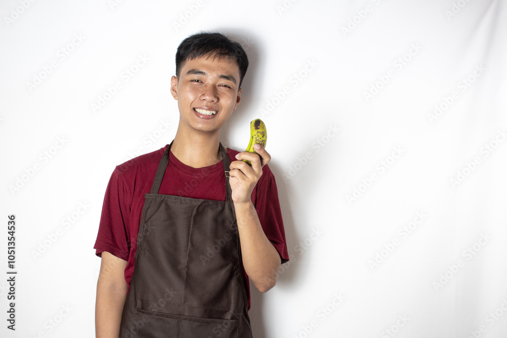 teenage bartender smiling and holding a banana teenage bartender smiling and holding a banana