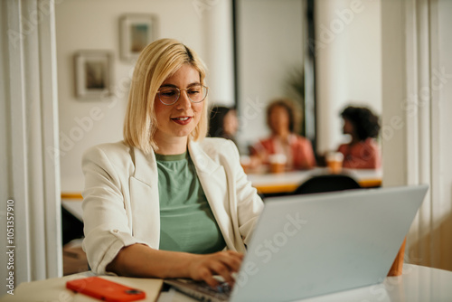 Shot of a young woman using a laptop for video conference. Smiling businesswoman in a video call using laptop in the office.