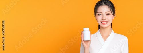 Asian Woman Skincare Ritual: Holding a Supplement Bottle While Gently Caressing Her Smooth Skin for a Glowing Complexion photo