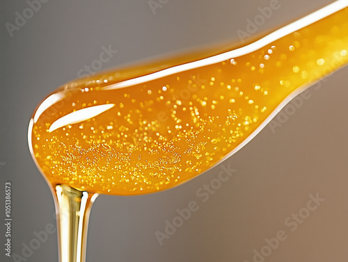 Pure Golden Honey Dripping from Above with Rich, Clear Texture and Glossy Natural Sweetness in Mid-Air photo