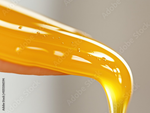 Fresh Clear Honey Dripping Down, Capturing the Essence of Sweetness, Golden Hue, and Natural Flow photo