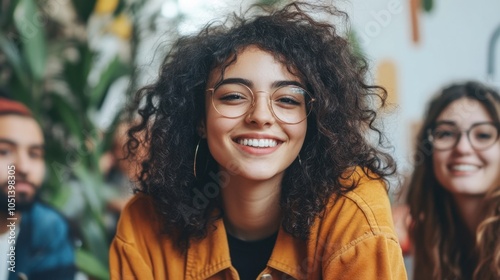 Happy Woman with Curly Hair and Glasses Smiling at Camera