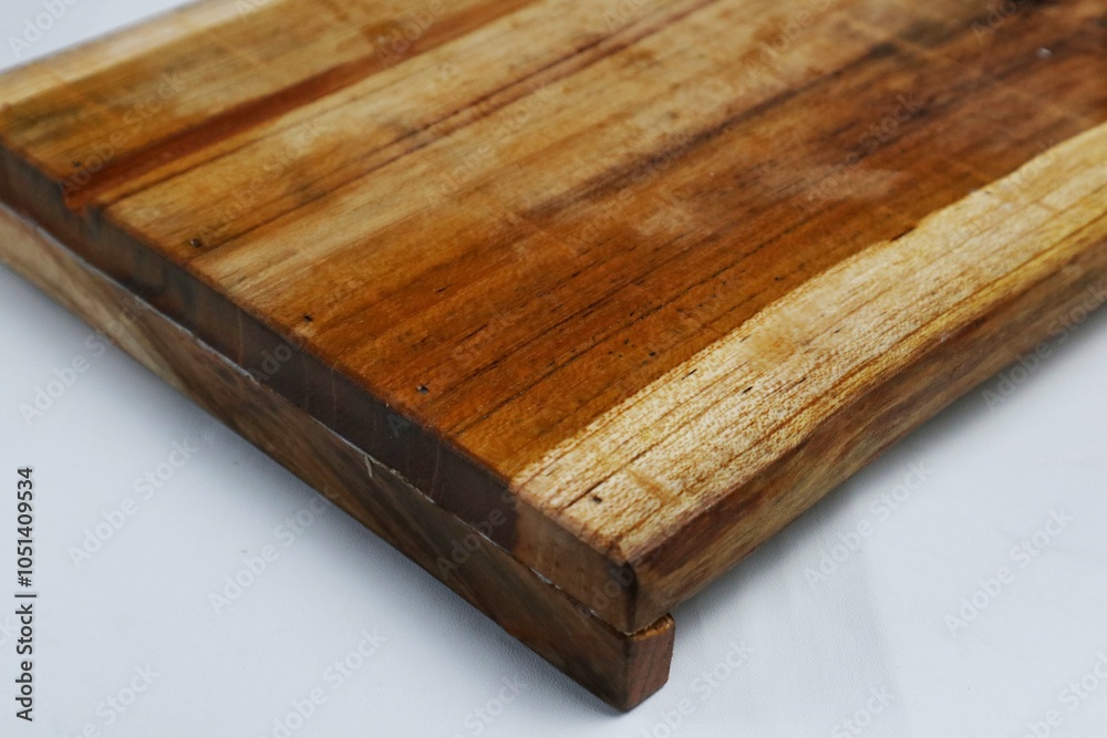 Square wooden cutting board isolated on white background with 45 degree angle setting