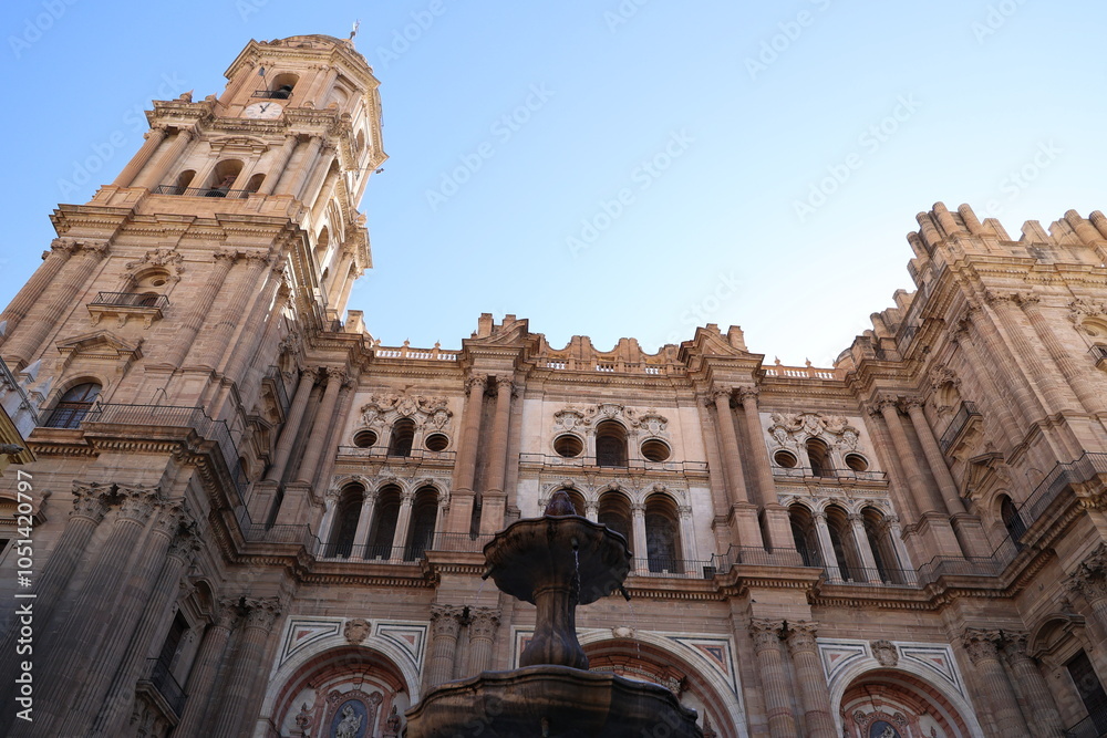 Naklejka premium Fountain with the Cathedral of Malaga- Basilica of the Incarnation in the background, Andalusia, Spain 