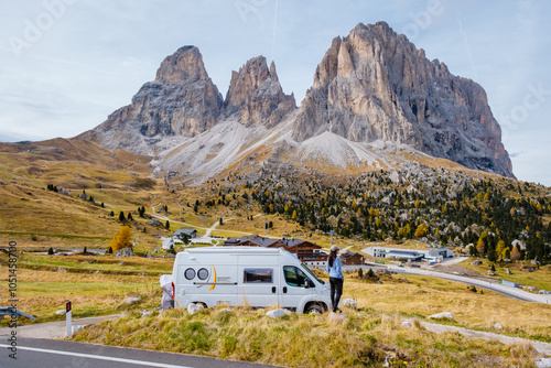 Exploring the breathtaking Dolomites in a camper van on a crisp autumn day photo