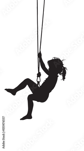 Black silhouette of baby girl flying high with fun on rope swing