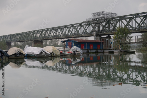 Obraz na płótnie GPS INSIDE Flood River Po Ticino Bridge Becca water banks trees boats harbor panorama nature landscape w salonie