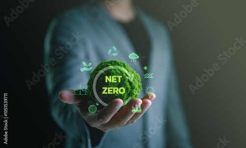 Businessman hand holding globe with Net Zero icon. Climate neutral long term strategy. Decarbonization sustainability, greenhouse gas emissions target, reduce carbon footprint.