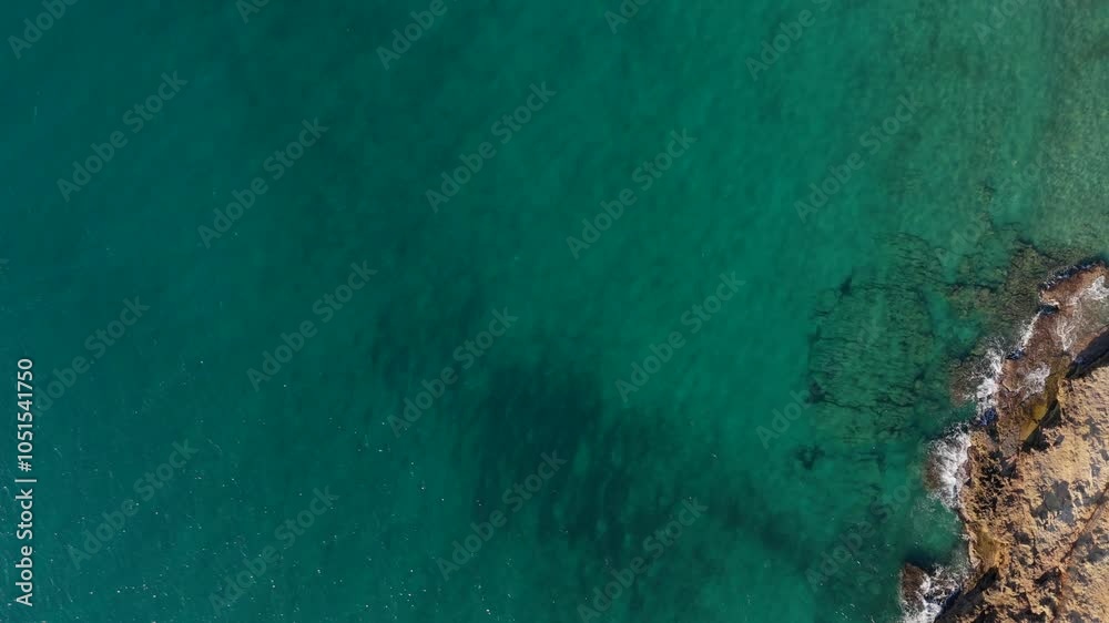 Clear turquoise waters and rocky coastline in Creta, Greece under bright sunlight Clear turquoise waters and rocky coastline in Creta, Greece under bright sunlight