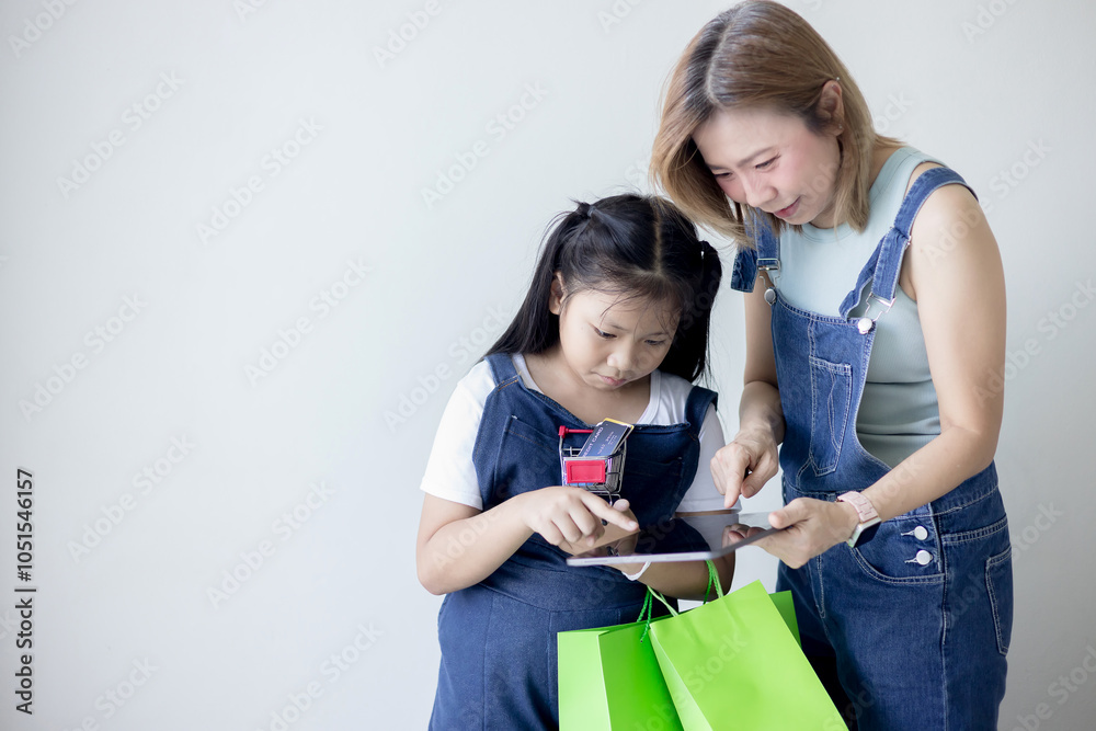 Mother and daughter shopping online with tablet Mother and daughter shopping online with tablet