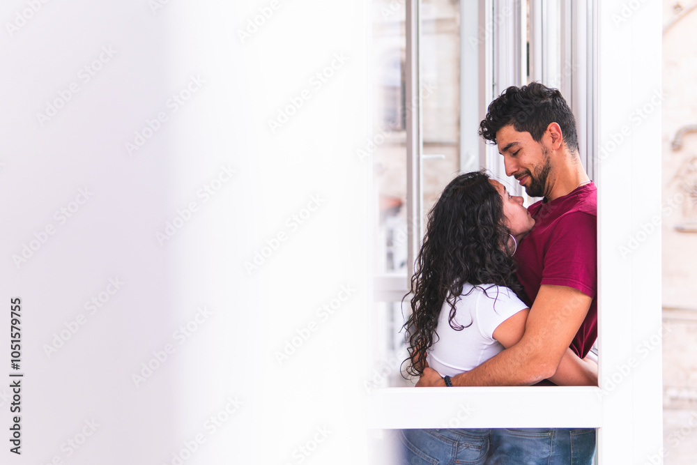 Smiling romantic man embracing girlfriend at home Smiling romantic man embracing girlfriend at home