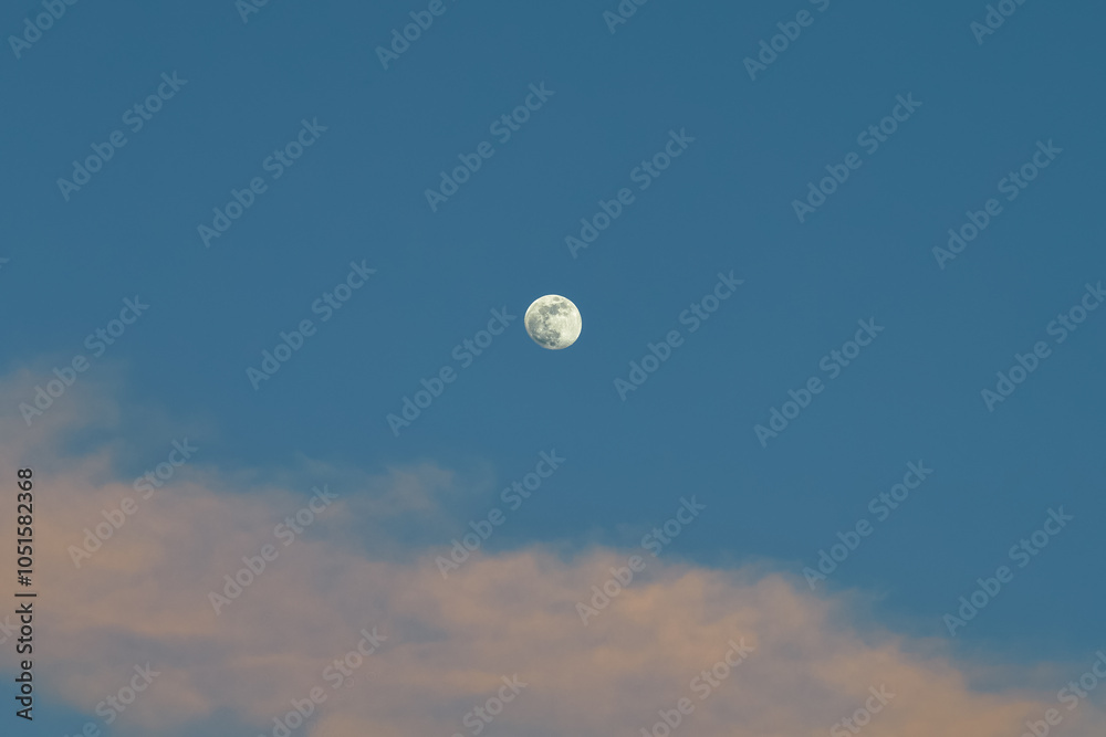 Full moon in the blue sky, with clouds, on a bright day. Full moon in the blue sky, with clouds, on a bright day.