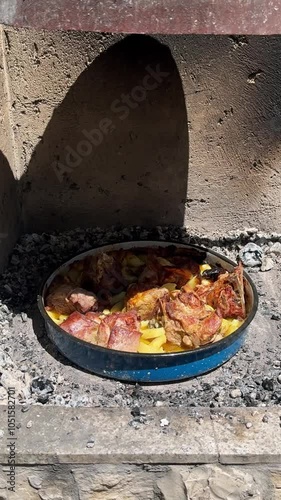 traditional Croatian food, peka made with roasted meat and vegetables in baking dish cooked under a metal bell-shaped dome