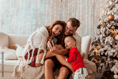 young family taking selfie at home and using smartphone, Christmas concept, holidays