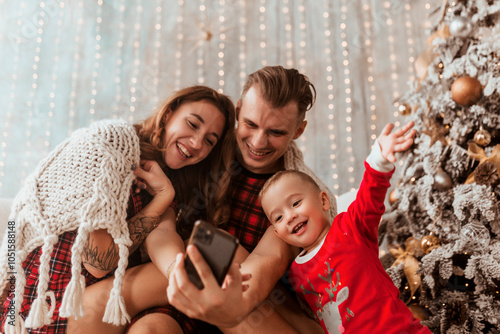 young family taking selfie at home and having fun, Christmas concept, holidays