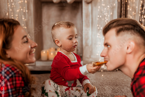 young family at home in Christmas decor eating pizza