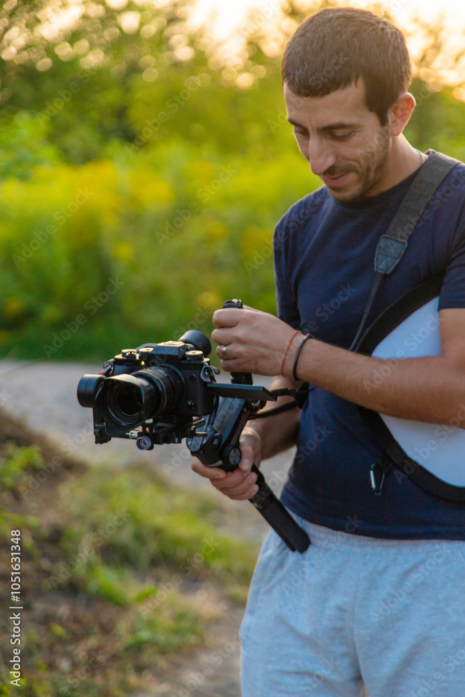 The operator shoots a video on a camera. Selective focus. The operator shoots a video on a camera. Selective focus.