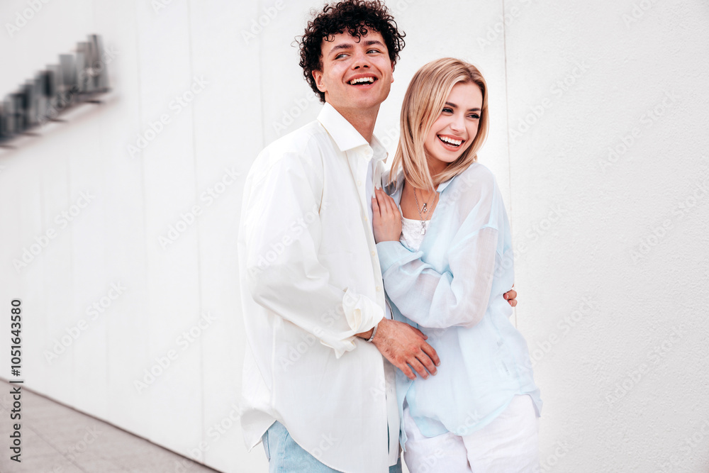 Smiling beautiful woman and her handsome boyfriend. Couple in casual summer clothes. Happy cheerful family. Female and man having fun. They posing in the street in sunny day. Having tender moments Smiling beautiful woman and her handsome boyfriend. Couple in casual summer clothes. Happy cheerful family. Female and man having fun. They posing in the street in sunny day. Having tender moments
