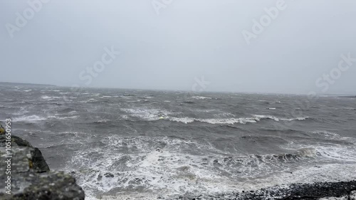 View in Kilrush, Ireland, during a storm in the Atlantic Ocean. Choppy waves crash photo